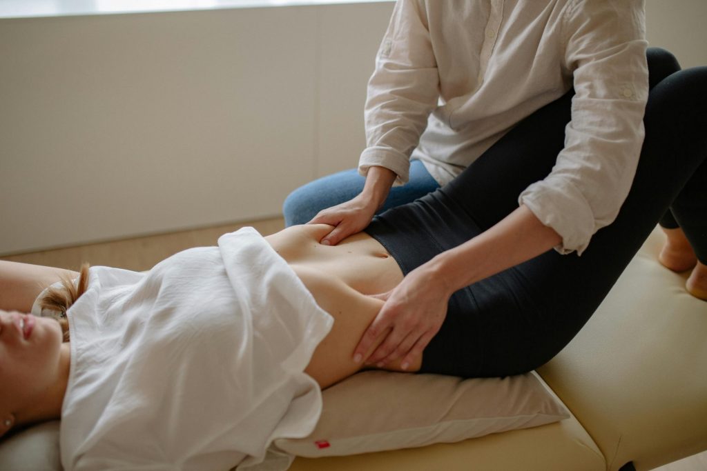 Woman receiving a therapeutic massage at a spa, focusing on relaxation and wellness.
